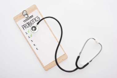 top view of clipboard with probiotics empty list and stethoscope on white background clipart