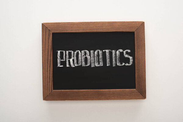 top view of chalkboard with probiotics lettering on white background