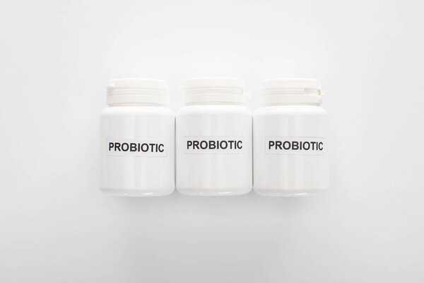 top view of containers with probiotic lettering on white background