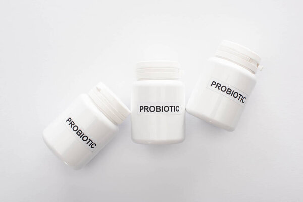 top view of containers with probiotic lettering on white background