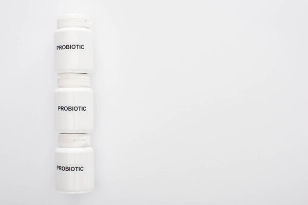 top view of containers with probiotic lettering on white background