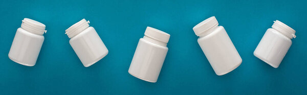 top view of white containers on blue background, panoramic shot