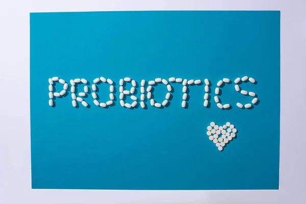 Horní Pohled Probiotika Písmo Srdce Pilulek Modrém Bílém Pozadí — Stock fotografie