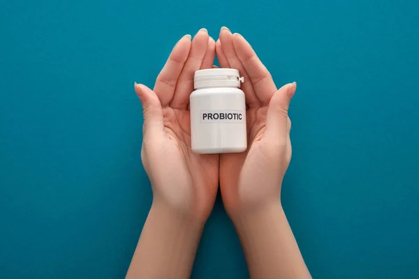 Cropped View Woman Holding White Probiotic Container Hands Blue Background — Stock Photo, Image