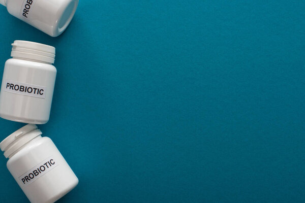 top view of containers with probiotic lettering on blue background