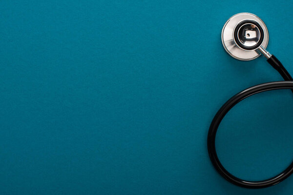 top view of stethoscope on blue background