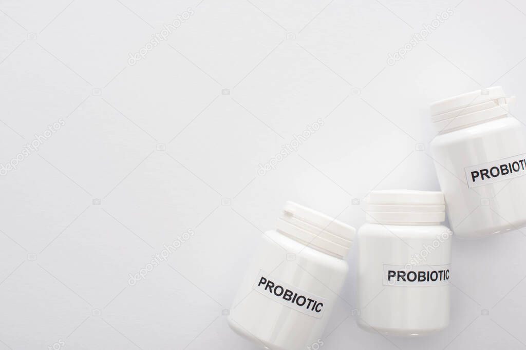 top view of containers with probiotic lettering on white background