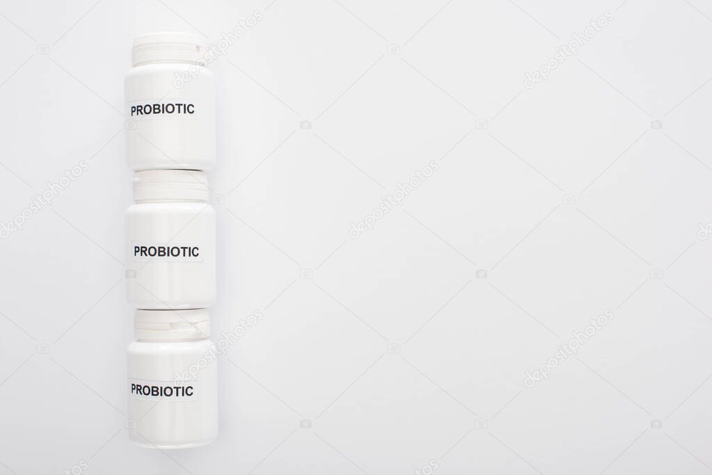 top view of containers with probiotic lettering on white background