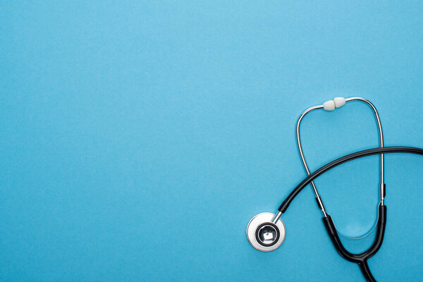 top view of stereoscope on blue background with copy space
