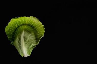 top view of wet green cabbage leaves isolated on black clipart