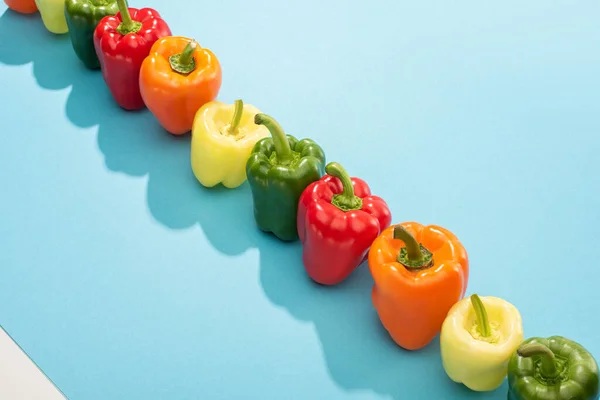 Fresh Colorful Bell Peppers Row Blue Surface — Stock Photo, Image