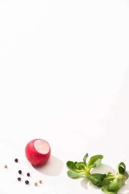 delicious radish and greens with black pepper on white background clipart