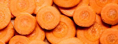 top view of fresh ripe carrot slices background, panoramic crop clipart