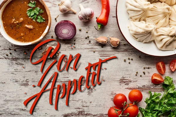 Top view of delicious khinkali, kharcho near vegetables and spices on wooden table, bon appetit illustration — Stock Image Top View Delicious Khinkali Kharcho Vegetables Spices Wooden Table Bon Royalty Free Stock Images
