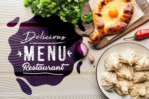 Top view of delicious khinkali and adjarian khachapuri near vegetables and spices on beige textured background, delicious menu restaurant illustration — Stock Image Top View Delicious Khinkali Adjarian Khachapuri Vegetables Spices Beige Textured Royalty Free Stock Photos