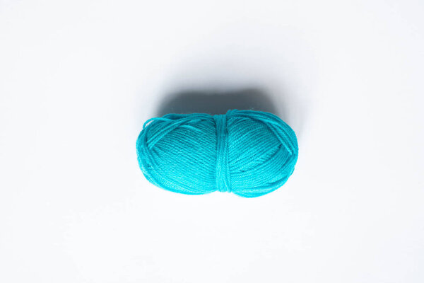 top view of blue wool yarn on white background