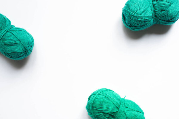top view of green wool yarn on white background
