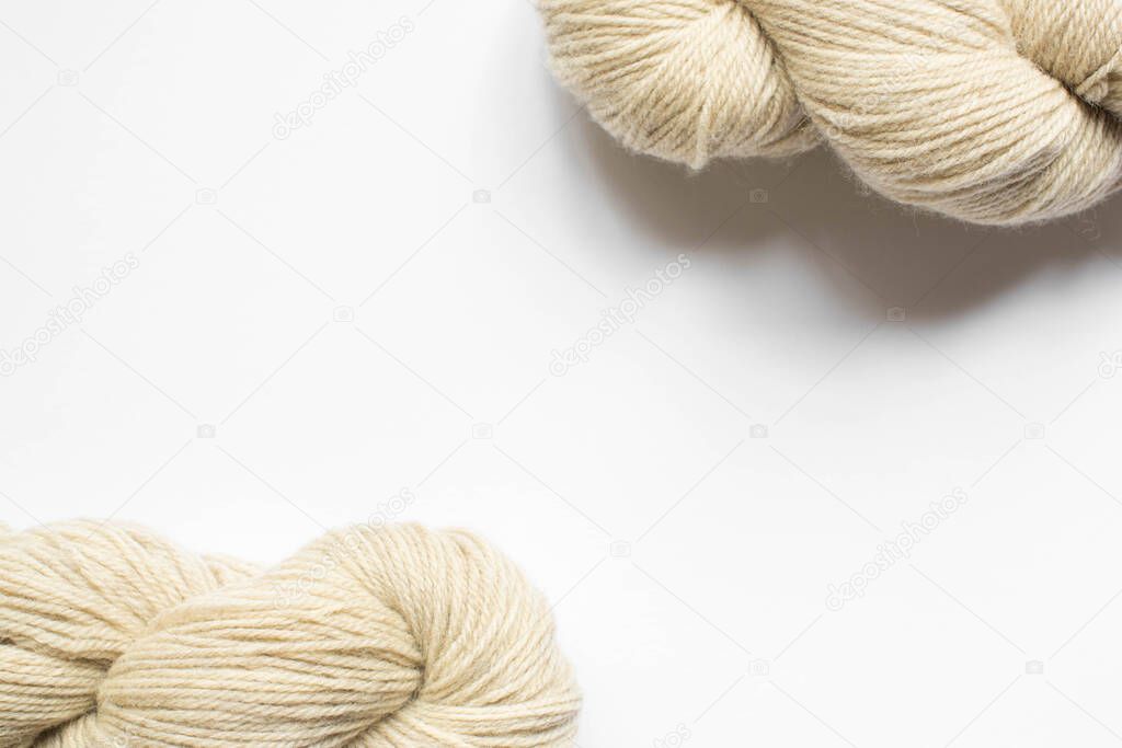 beige yarn on white background with copy space