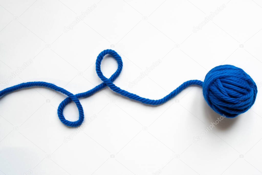 top view of blue wool yarn on white background