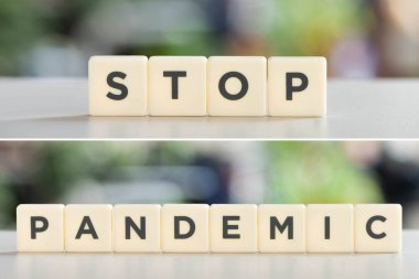 white cubes with stop pandemic lettering on white desk, covid-19 concept clipart