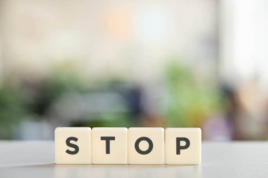 white cubes with stop lettering on white desk clipart