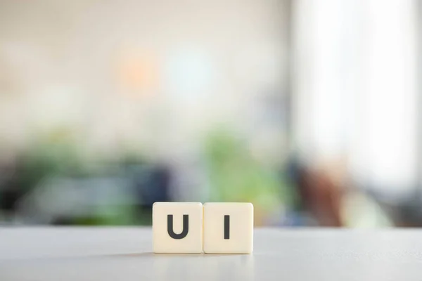 white cubes with ui lettering on office desk