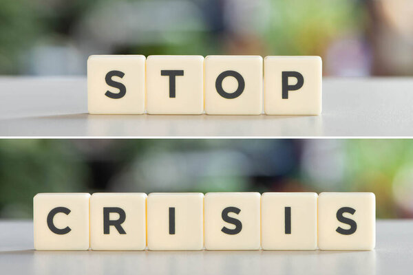 collage of white cubes with stop crisis words on white surface