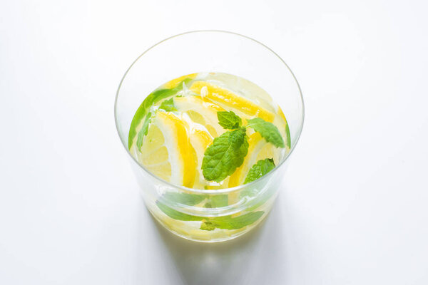 fresh lemonade in glass with mint on white background