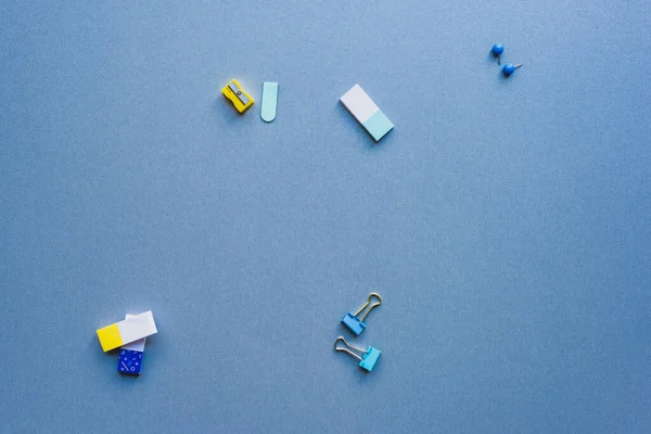 Top View Pencil Sharpener Binder Clips Erasers Blue Background — Stock Photo, Image