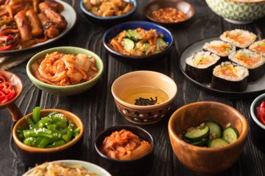 Ahşap yüzeyde geleneksel ve baharatlı Kore yemeklerinin seçici odak noktası 