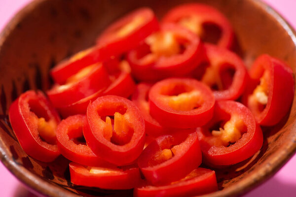 close up of red and spicy chili peppers in bowl