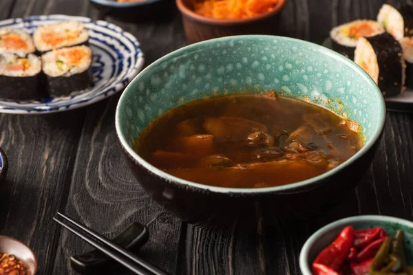 Selective focus of ramen near korean kimbap and chili peppers — Stock Image Selective Focus Ramen Korean Kimbap Chili Peppers Stock Photo