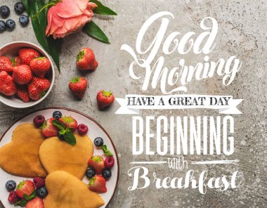 top view of heart shaped pancakes with berries on grey concrete surface with blooming rose, good morning, have great beginning with breakfast illustration clipart