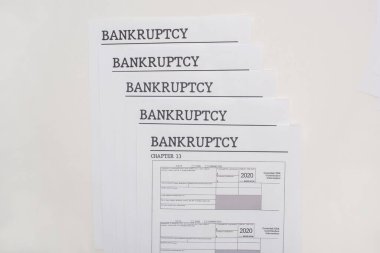 top view of bankruptcy papers on white background clipart