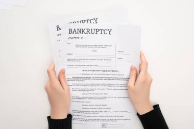 partial view of woman holding bankruptcy papers on white background clipart