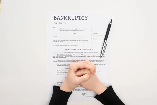 Cropped View Female Clenched Hands Bankruptcy Paper Pen White Background — Stock Photo, Image