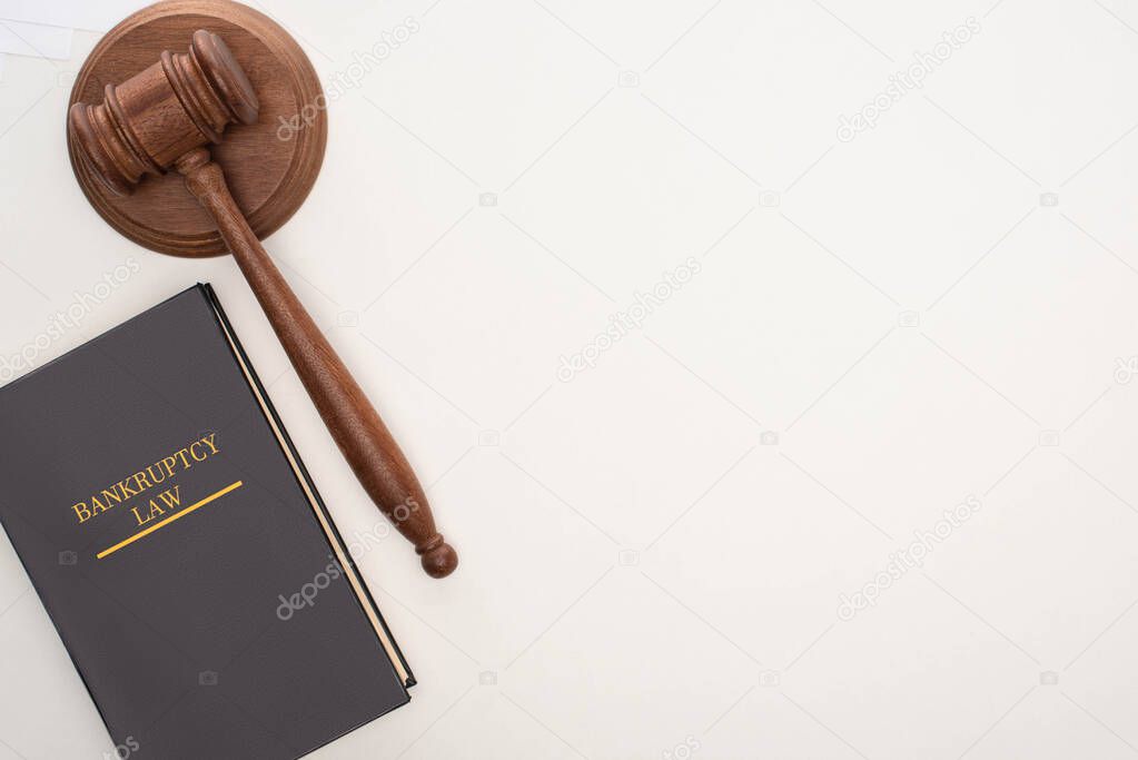 top view of bankruptcy law book and gavel on white background