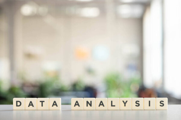  white cubes with data analysis inscription on white surface