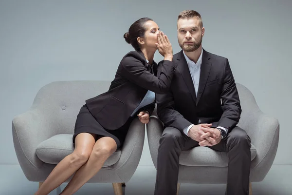 Business people sitting on chairs — Stock Photo