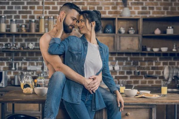 Couple hugging in kitchen — Stock Photo
