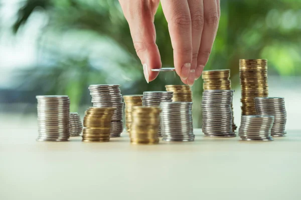 Person stacking coins — Stock Photo