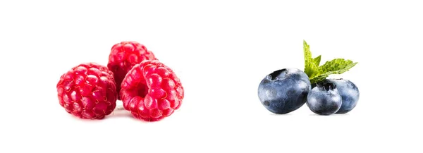 Piles of raspberries and blueberries — Stock Photo