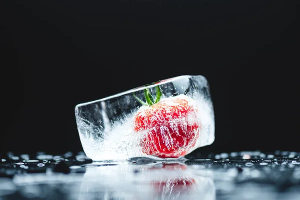 Cherry tomato in ice cube — Stock Photo