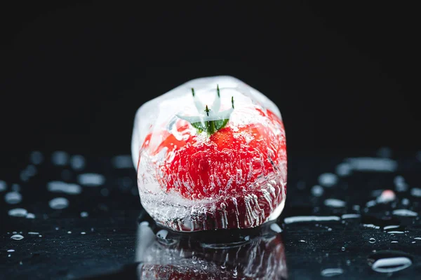Cherry tomato in ice cube — Stock Photo