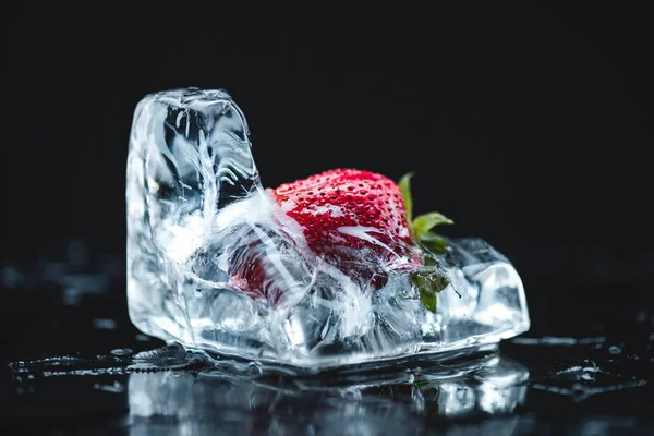 Strawberry frozen in ice cube — Stock Photo