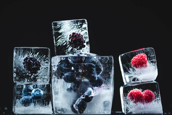Frozen fruits in ice cubes — Stock Photo