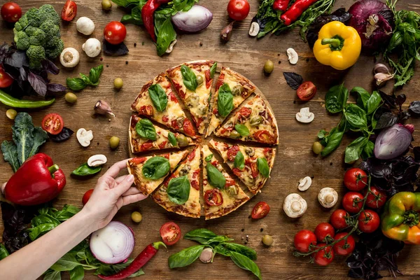 Donna che prende fetta di pizza — Foto stock