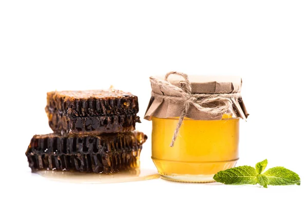 Honeycombs and honey in glass jar — Stock Photo
