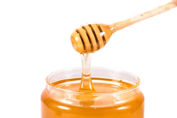 Miel fresca en frasco de vidrio - foto de stock