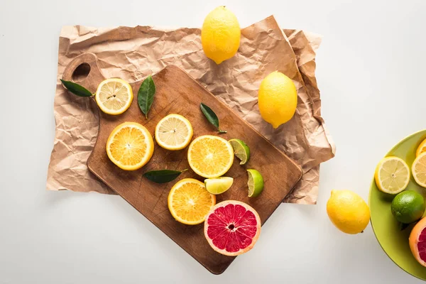 Citrus fruits on cutting board — Stock Photo